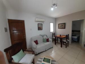 a living room with a white couch and a table at Caseros Centro in San Juan +6 photos