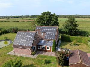 an aerial view of a house with solar panels on it at Apartment, Essen in Esens