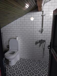 a bathroom with a toilet and a tiled floor at ZEMAHOTEL in Buyukcekmece