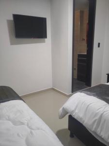 Postel nebo postele na pokoji v ubytování Hotel Cacique