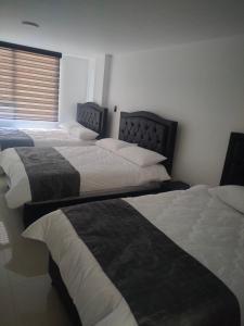 Postel nebo postele na pokoji v ubytování Hotel Cacique