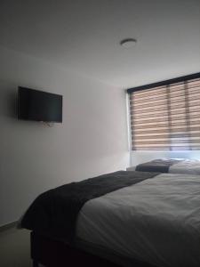 Postel nebo postele na pokoji v ubytování Hotel Cacique