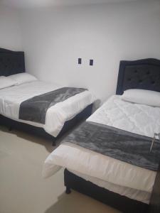 Postel nebo postele na pokoji v ubytování Hotel Cacique