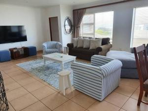 a living room with a couch and a table at 29 Jeffs Place in Yzerfontein