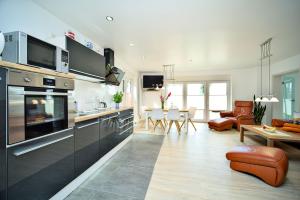 a kitchen and living room with a dining room at Fewo Usedom Peene Idyll in Wolgast