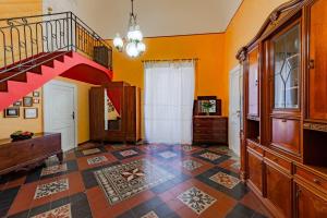 a living room with a staircase and a tiled floor at B&B TOMMASO FAZELLO SCIACCA Residenza artistica in Sciacca