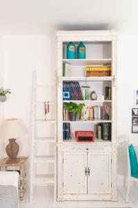 a white bookcase in a living room with a ladder at La Casa di Mila in Fermo