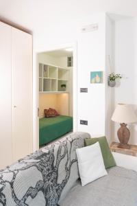 uma sala de estar com uma cama e um espelho em La Casa di Mila em Fermo
