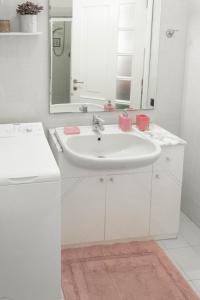a white bathroom with a sink and a mirror at La Casa di Mila in Fermo +12 photos