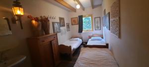 a room with two beds and a sink and a bathroom at De Linde, boerderij in Drenthe voor 15 tot 30 personen in Linde