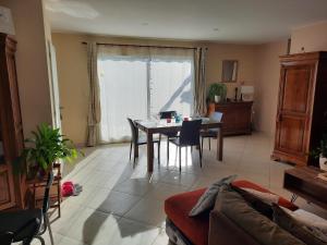 a living room with a table and a couch at CLOS DES ROMPUDES in Aramon