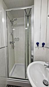 a bathroom with a shower and a sink at Breeze B&B in Llandudno