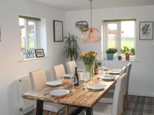 a dining room with a wooden table and chairs at Hornby Cottage in Saint Michaels on Wyre
