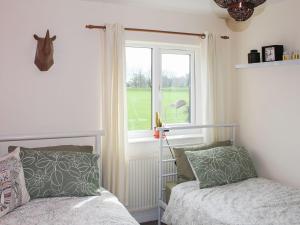 a bedroom with a bed and a window at Hornby Cottage in Saint Michaels on Wyre