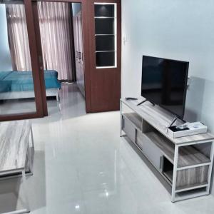 a living room with a flat screen tv on a table at SLEPTOPIA at formosa lvl27 budget unit city and sea view in nagoya jodoh in Jodoh