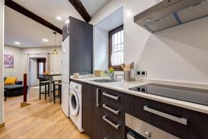 a kitchen with a sink and a dishwasher at Apartamentos Menorá in Toledo