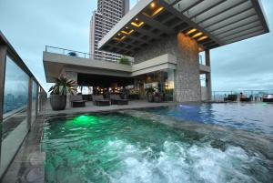 a swimming pool on the roof of a building at City Garden Grand Hotel in Manila