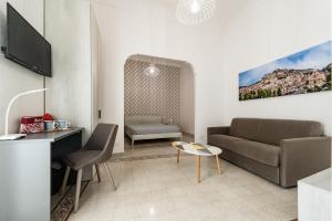 a living room with a couch and a table at Casa Melina in Scicli