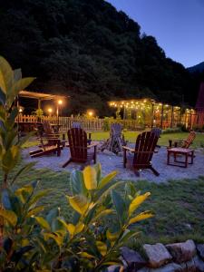 a group of chairs sitting in a yard at night at DREAM RIVER EXCLUSIVE BUNGALOW in Çamlıhemşin