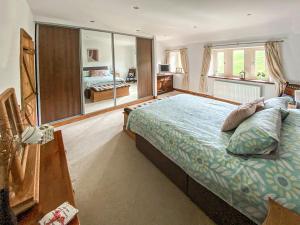 a bedroom with a large bed and a large window at Cooper Cabana in Elslack