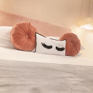a bed with two pillows with lashes on it at Tama Rooms in Rome