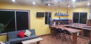 a kitchen with a bar with a couch and a table at The Spot @ Cocles in Puerto Viejo