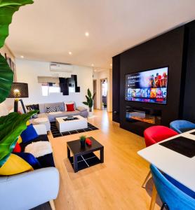 a living room with a couch and a tv at Privilege House jade in Marrakesh