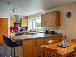 a kitchen with a table and a dining room at Southview Cottage in Cupar