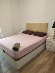a bedroom with a bed with a white bed frame at Premier Apartments in Valencia