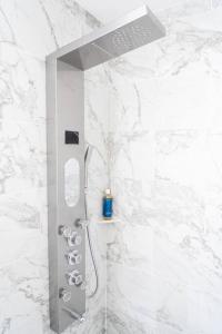 a shower in a bathroom with white marble walls at Studio- Sleep 2,Pool, Parking,5min walk to Beach -3 in Fort Lauderdale