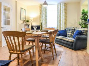 a living room with a table and chairs and a couch at Ring Of Bells in South Molton