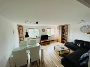 a living room with a couch and a table at Ferienwohnung Bürgel Ebersbach Fils in Ebersbach an der Fils