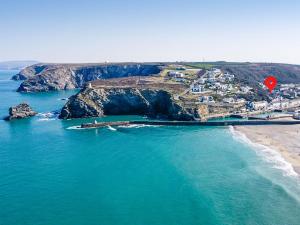 an aerial view of a beach with a red sign at The Chalet in Portreath