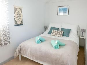 a bedroom with a bed with two pillows on it at The Chalet in Portreath