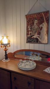 un tavolo con un piatto di bicchieri da vino sopra di Amiens Cottage. Queenslander, charming, central. a Stanthorpe