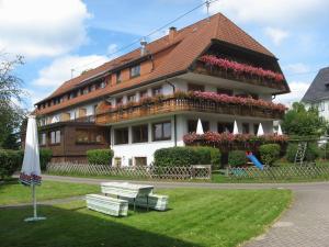 a building with flowers in front of it at Hotel Gasthof Straub in Lenzkirch