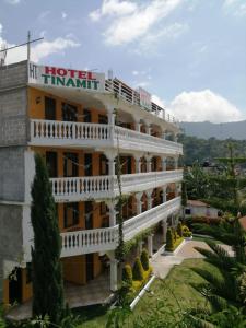 a large hotel with a balcony on top of it at Hotel Tinamit in San Pedro La Laguna