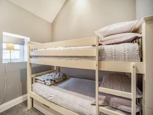 a bunk bed room with two bunk beds at Cherrytree Cottage in Chatton