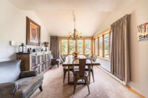 a dining room with a table and a couch at Pines by Summit County Mountain Retreats in Keystone