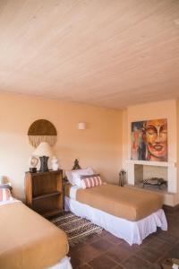 a bedroom with two beds and a painting on the wall at Casa Mario Boutique Hotel 