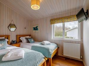 a bedroom with two beds and a window at Acer Lodge-uk37594 in Willington