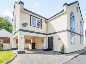 a large white house with a driveway at Capel Y Ffynnon in Llandudno Junction