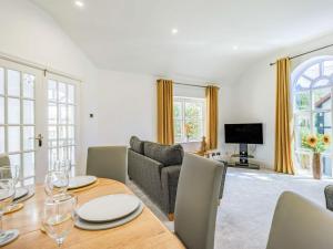 a living room with a table and a couch at Capel Y Ffynnon in Llandudno Junction