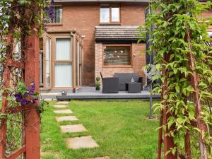 a garden with two chairs and a table in a yard at Zebra House in Blaenavon