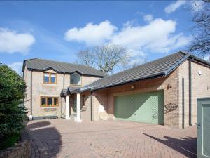 a large brick house with a large garage at Lark Rise in Northam