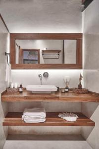 a bathroom with a sink and a mirror at Hotel Boutique TerraNova in Tulum