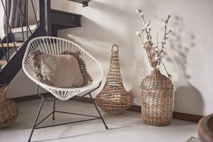 a room with a chair and vases on the floor at Hotel Boutique TerraNova in Tulum