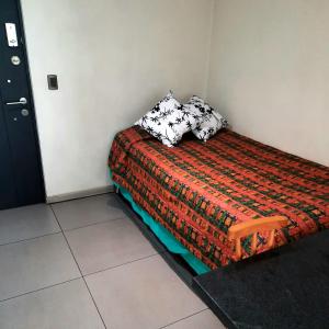 - un petit lit avec 2 oreillers dans l'établissement R&V Apartments, à Santiago