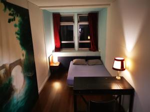 a small room with a bed and a window at Adventure Alternative - GUEST HOUSE - Arts-Factory-Experience - For artists, makers and open minds - Attention, we are not a hotel and are not adapted for everybody - Read host warnings before reservation - PROVIDENCE,BE asbl in Charleroi +75 photos