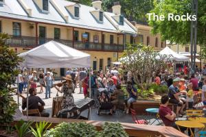 a crowd of people sitting around in a courtyard at CBD Curated Comfort, Resort Style Living in Sydney